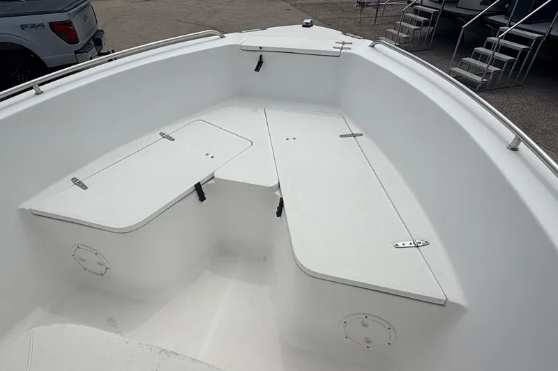 Slide: The Image of 2007 Sea Hunt Triton 220 boat interior with white seating and storage compartments. - 11