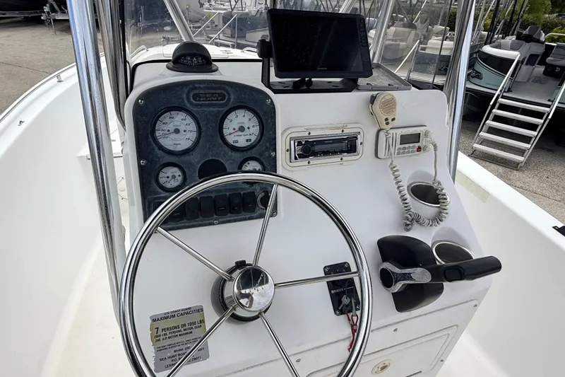 Slide: The Image of 2007 Sea Hunt Triton 220 boat dashboard with steering wheel and navigation instruments. - 16