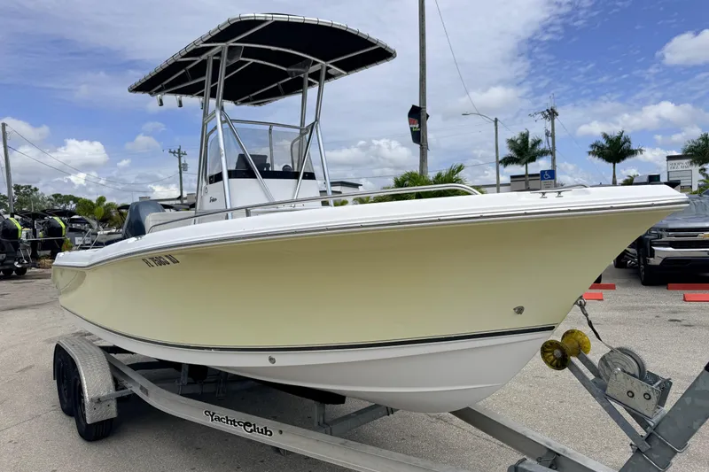 Slide: The Image of 2007 Sea Hunt Triton 220 boat on trailer, parked outdoors under a blue sky. - 3
