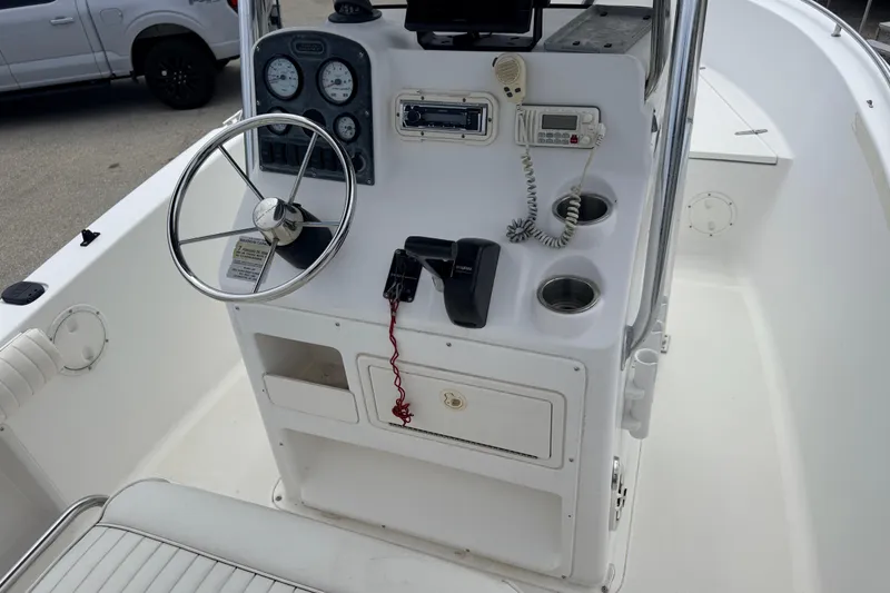 Slide: The Image of 2007 Sea Hunt Triton 220 boat console with steering wheel and navigation controls. - 8