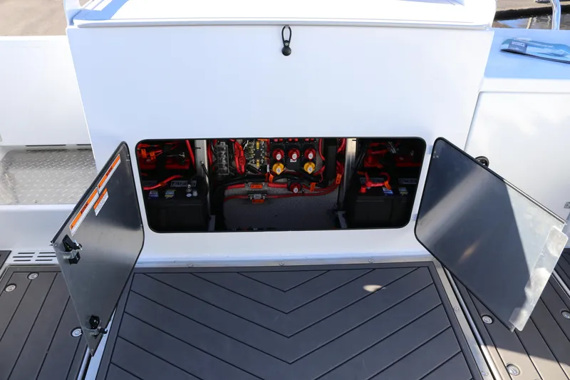 Slide: The Image of Open compartment of 2026 KingFisher 3425 GFX Offshore boat showing electrical components. - 14