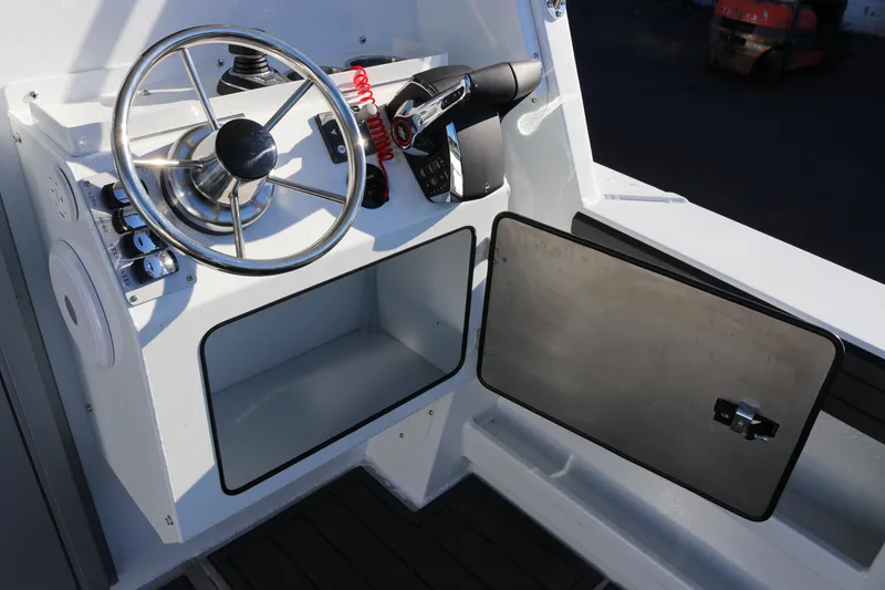 Slide: The Image of 2026 KingFisher 3425 GFX Offshore helm with steering wheel and control panel. - 15