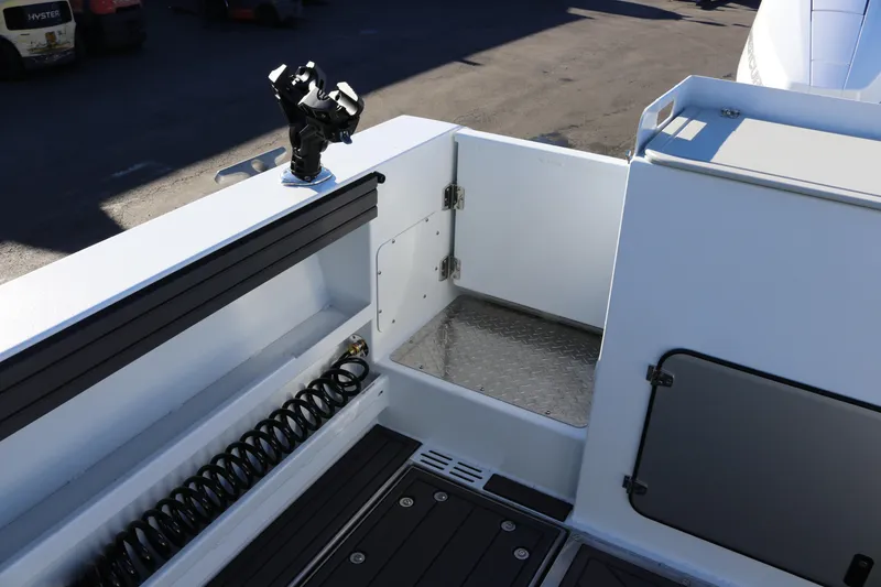 Slide: The Image of KingFisher 3425 GFX Offshore 2026 boat deck with rod holder and storage compartment. - 18