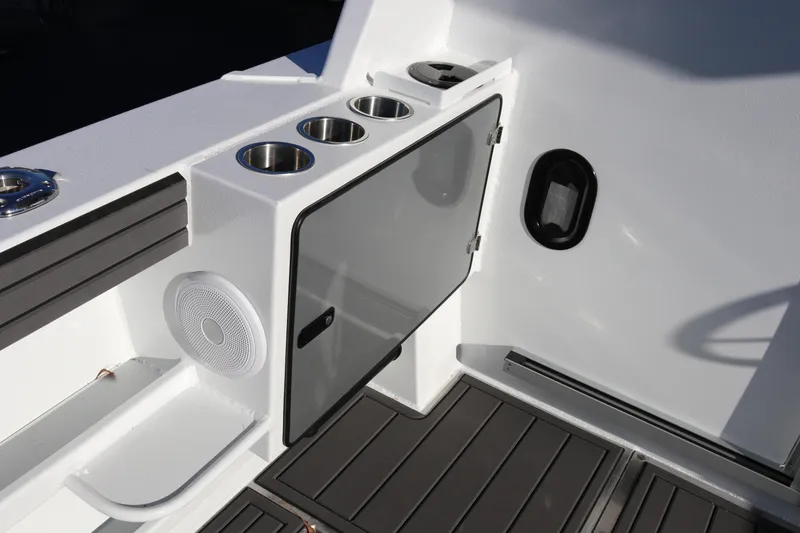 Slide: The Image of 2026 KingFisher 3425 GFX Offshore boat interior with cup holders and storage compartment. - 19
