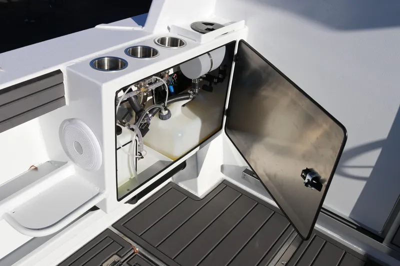Slide: The Image of Interior view of 2026 KingFisher 3425 GFX Offshore boat's storage compartment and cup holders. - 20