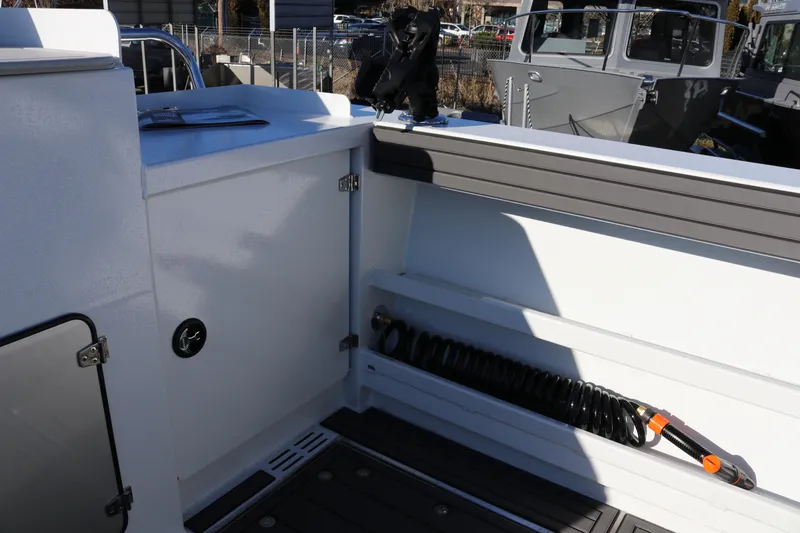 Slide: The Image of Interior view of 2026 KingFisher 3425 GFX Offshore boat, featuring storage and hose compartment. - 23