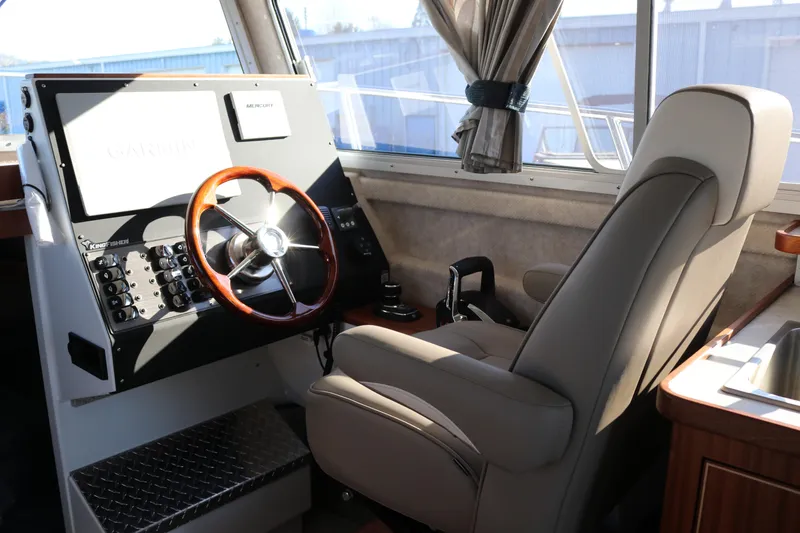Slide: The Image of Interior of 2026 KingFisher 3425 GFX Offshore boat with steering wheel and controls. - 31