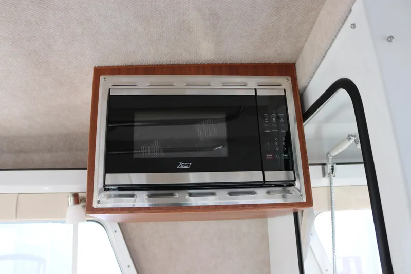 Slide: The Image of Built-in microwave in 2026 KingFisher 3425 GFX Offshore boat interior. - 42