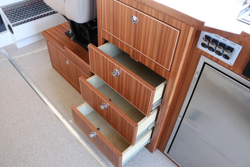Slide: The Image of Wooden drawers and control panel inside 2026 KingFisher 3425 GFX Offshore boat cabin. - 43