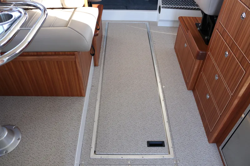 Slide: The Image of Interior of 2026 KingFisher 3425 GFX Offshore boat, featuring seating and storage compartments. - 46