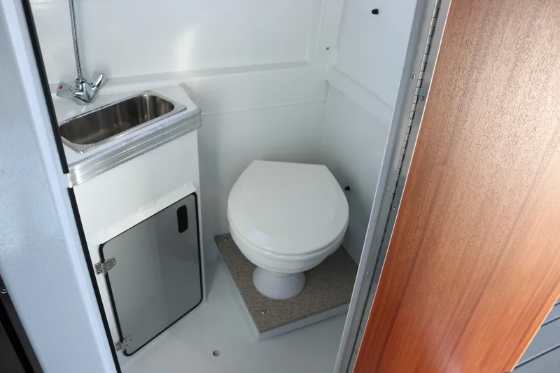 Slide: The Image of Compact bathroom in 2026 KingFisher 3425 GFX Offshore boat with sink and toilet. - 48