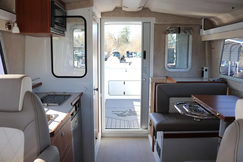 Slide: The Image of Interior of 2026 KingFisher 3425 GFX Offshore boat, featuring modern kitchen and seating area. - 49