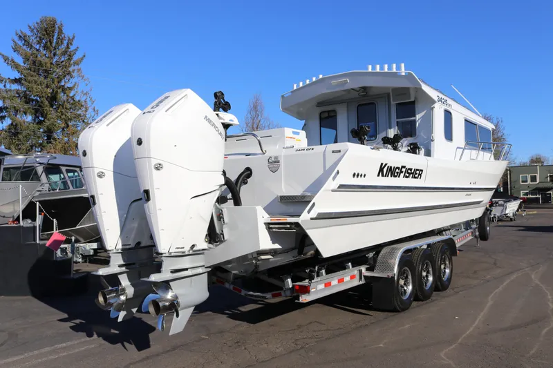 Slide: The Image of 2026 KingFisher 3425 GFX Offshore boat with dual outboard motors on a trailer. - 5