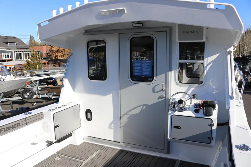 Slide: The Image of 2026 KingFisher 3425 GFX Offshore boat cockpit with steering wheel and control panel. - 7