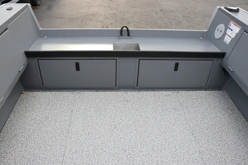 Slide: The Image of 2026 Alumaweld Columbia 23 boat interior with storage compartments and non-slip flooring. - 10