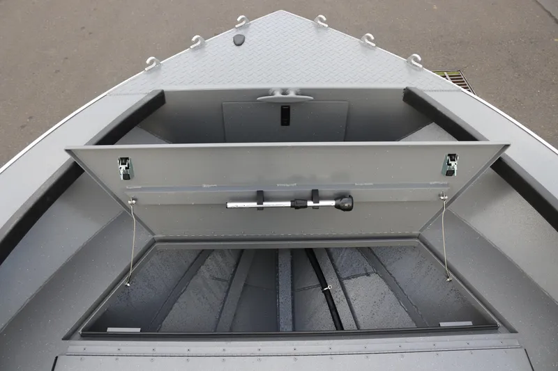 Slide: The Image of 2026 Alumaweld Columbia 23 boat storage compartment, open and empty, showcasing interior space. - 13