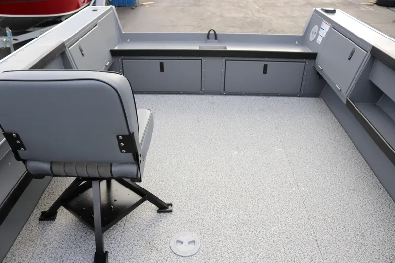 Slide: The Image of Interior of 2026 Alumaweld Columbia 23 boat with gray seating and storage compartments. - 17