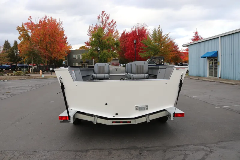 Slide: The Image of 2026 Alumaweld Columbia 23 boat on trailer, autumn trees in background. - 2