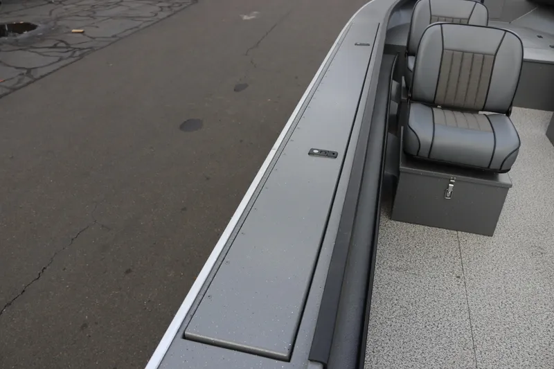 Slide: The Image of 2026 Alumaweld Columbia 23 boat interior with gray seating and storage compartments. - 20