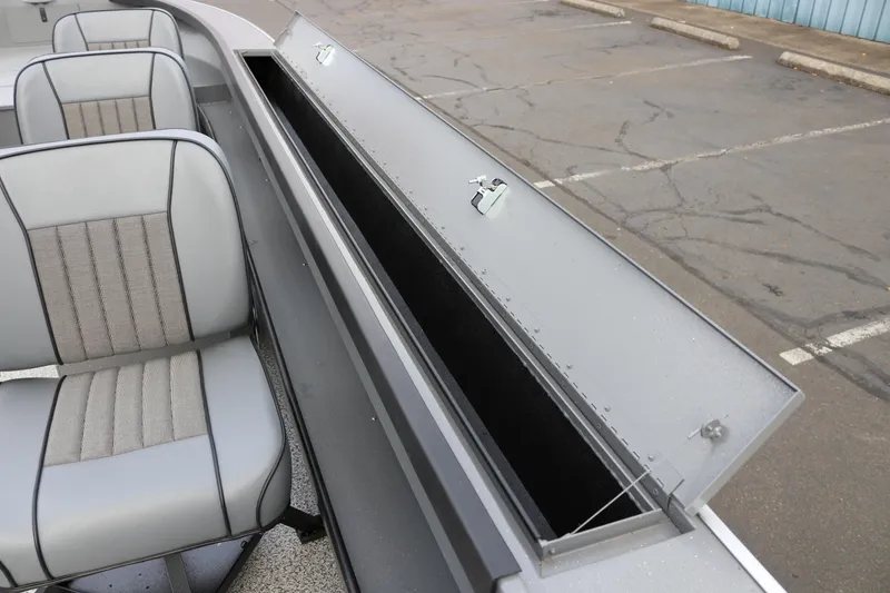 Slide: The Image of 2026 Alumaweld Columbia 23 boat interior with open storage compartment and seating. - 21