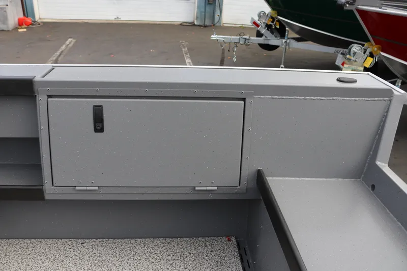 Slide: The Image of Interior view of 2026 Alumaweld Columbia 23 boat, featuring storage compartment and seating. - 26