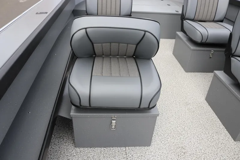 Slide: The Image of 2026 Alumaweld Columbia 23 boat interior with gray cushioned seating and storage compartments. - 29