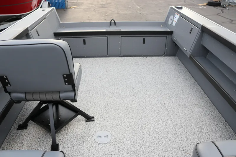 Slide: The Image of 2026 Alumaweld Columbia 23 boat interior with gray seating and storage compartments. - 9