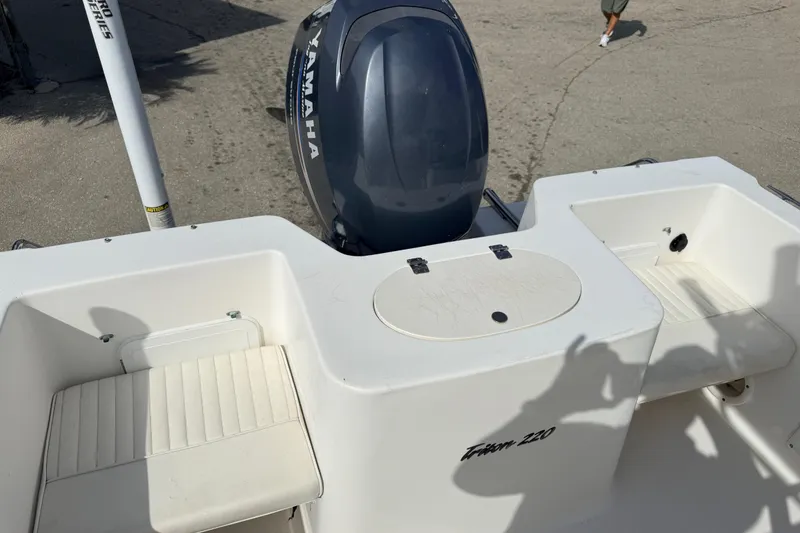 Slide: The Image of 2006 Sea Hunt Triton 220 boat with Yamaha outboard motor, featuring seating and storage compartments. - 10