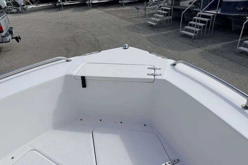 Slide: The Image of 2006 Sea Hunt Triton 220 boat bow with storage compartment and railings. - 14