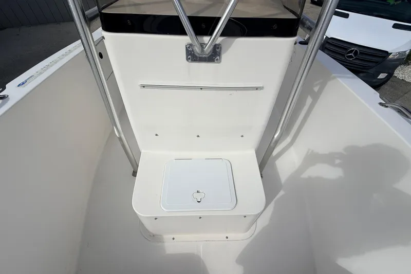 Slide: The Image of 2006 Sea Hunt Triton 220 boat interior with storage compartment and railing. - 15