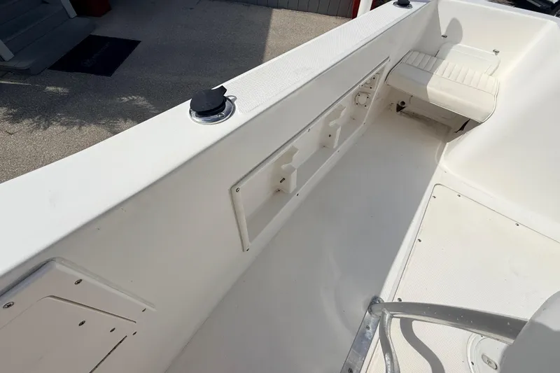 Slide: The Image of 2006 Sea Hunt Triton 220 boat interior with seating and storage compartments. - 18