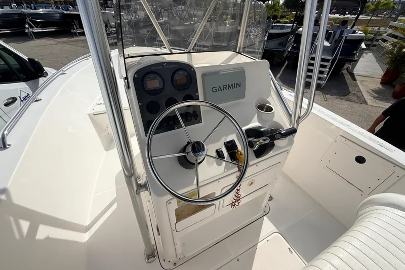 Slide: The Image of 2006 Sea Hunt Triton 220 boat dashboard with Garmin navigation system and steering wheel. - 20