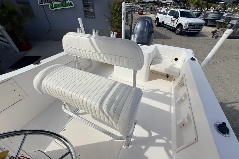 Slide: The Image of 2006 Sea Hunt Triton 220 boat interior with white seating and steering wheel. - 21