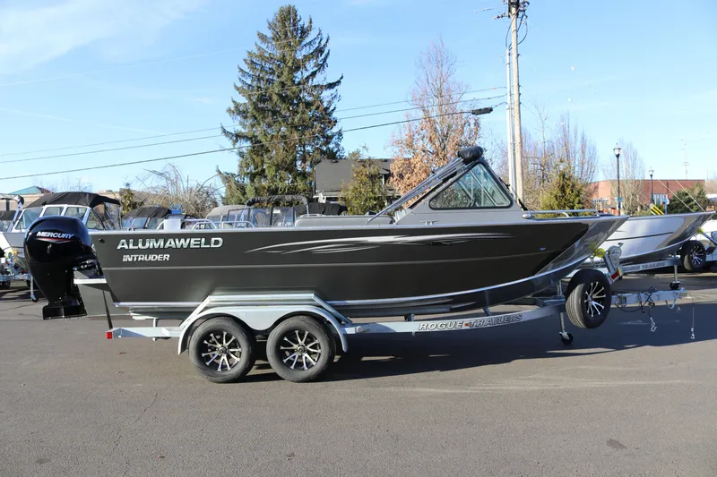 The Image of 2026 Alumaweld Intruder Outboard 20 boat on trailer, parked outdoors. - 1