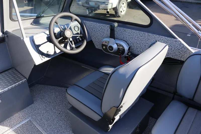 Slide: The Image of 2026 Alumaweld Intruder Outboard 20 boat interior with steering wheel and seating. - 12