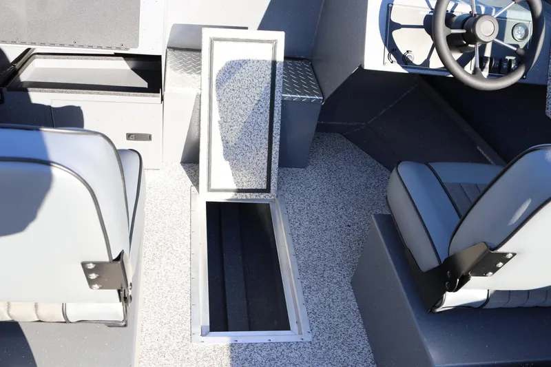 Slide: The Image of 2026 Alumaweld Intruder Outboard 20 interior with open storage compartment and seating. - 15