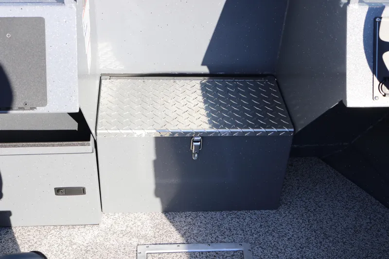 Slide: The Image of Alumaweld Intruder Outboard 20 (2026) storage compartment with diamond plate lid. - 16