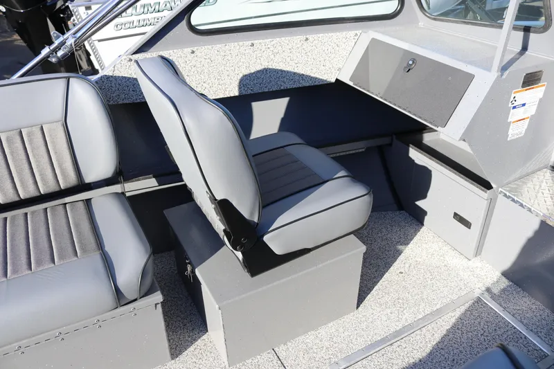 Slide: The Image of 2026 Alumaweld Intruder Outboard 20 interior with gray seating and storage compartments. - 24