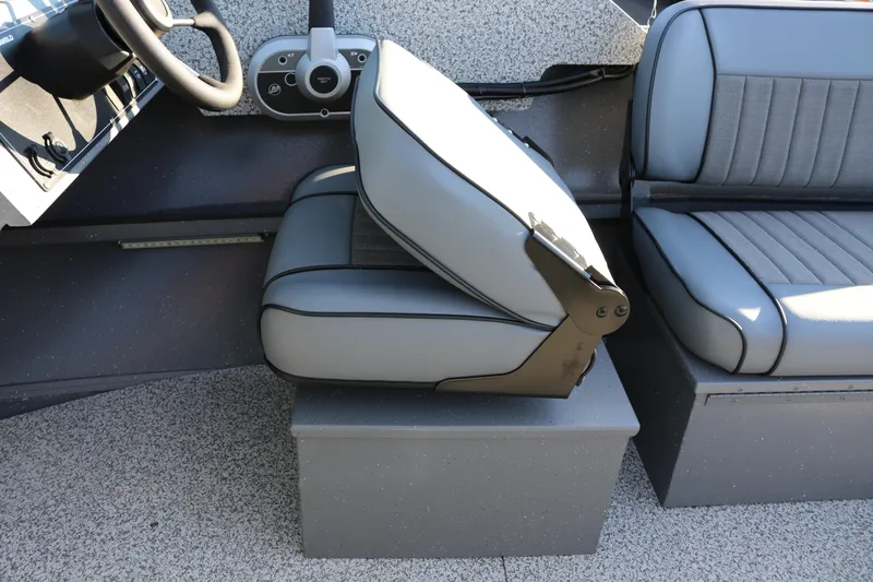 Slide: The Image of 2026 Alumaweld Intruder Outboard 20 boat interior with gray seating and steering wheel. - 27