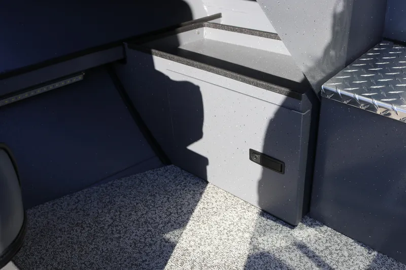 Slide: The Image of Interior of 2026 Alumaweld Intruder Outboard 20, featuring storage compartment and textured flooring. - 30