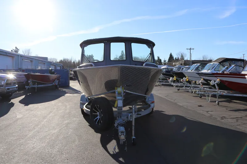 Slide: The Image of 2026 Alumaweld Intruder Outboard 20 boat on trailer in sunny dealership lot. - 5