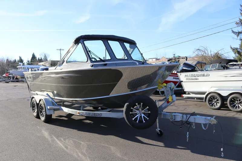 Slide: The Image of 2026 Alumaweld Intruder Outboard 20 boat on trailer, parked outdoors. - 6
