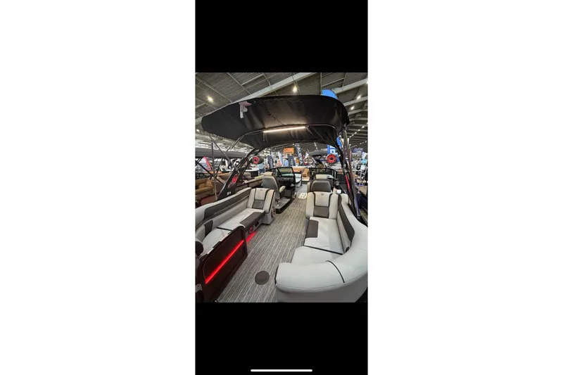 Slide: The Image of 2026 Premier 250 Solaris Sport pontoon boat interior with modern seating and canopy. - 6