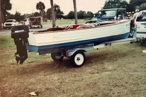 Slide: The Image of 1952 Lyman 15 Classic Runabout boat on trailer, parked outdoors. - 7