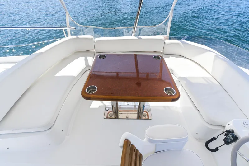 Slide: The Image of Flybridge seating area on 2013 Azimut Magellano 50 yacht with wooden table and ocean view. - 15