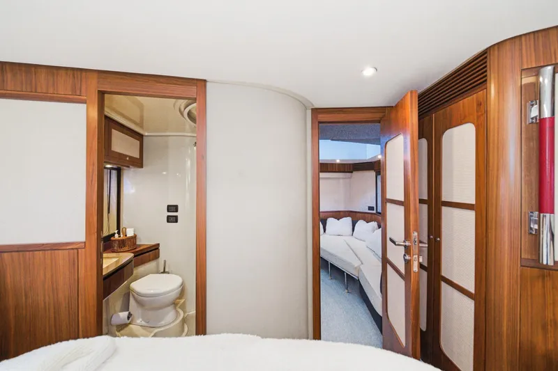 Slide: The Image of Interior of 2013 Azimut Magellano 50 yacht, featuring a bathroom and cozy cabin. - 16