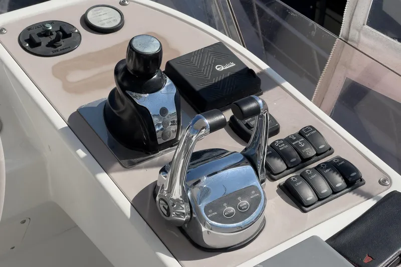 Slide: The Image of Control panel of a 2013 Azimut Magellano 50 yacht, featuring throttle and switches. - 24