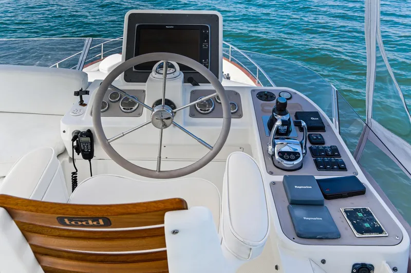 Slide: The Image of Helm of 2013 Azimut Magellano 50 yacht with modern navigation controls and steering wheel. - 27