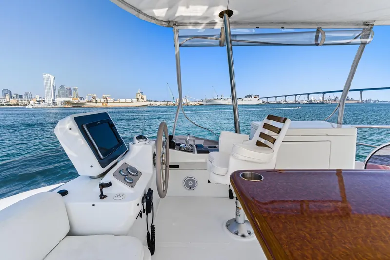 Slide: The Image of Cockpit view of 2013 Azimut Magellano 50 yacht with city skyline and bridge in background. - 32