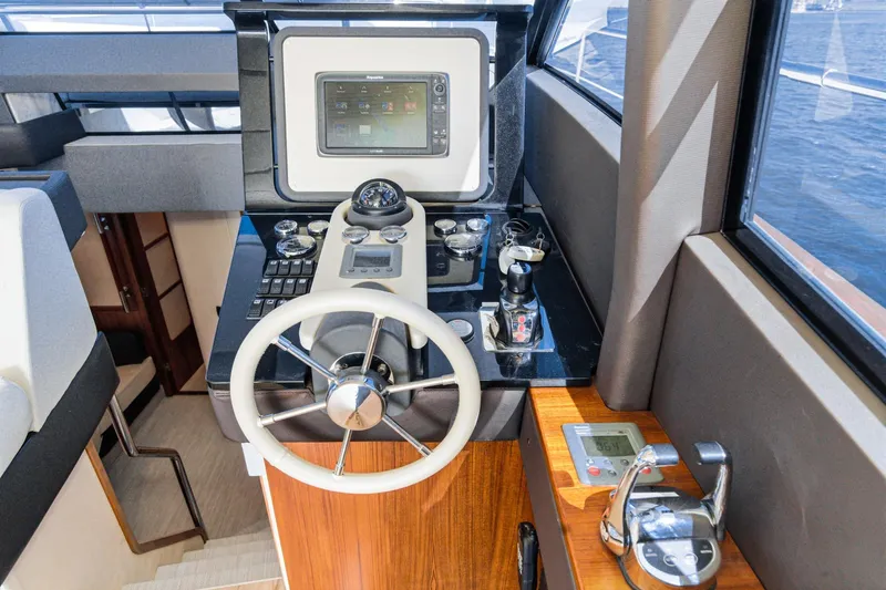Slide: The Image of Helm of 2013 Azimut Magellano 50 yacht with navigation controls and steering wheel. - 36